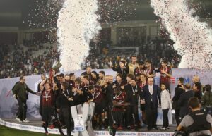 DOHA, QATAR - DECEMBER 23 : AC Milan team celebrating with Trophy  after winning the Supercoppa TIM Doha 2016 match between Juventus FC and AC Milan at the Jassim Bin Hamad Stadium on December 23, 2016 in Doha, Qatar. (Photo by AK BijuRaj/Getty Images)